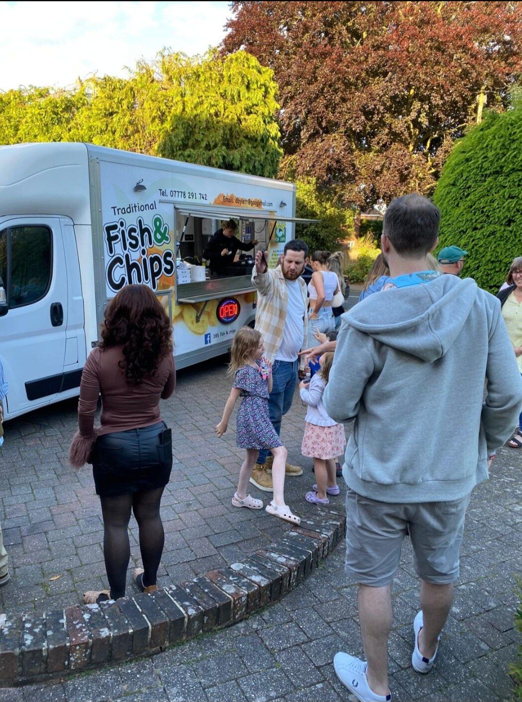 Guests queuing at the DB's traditional fish and chip van at a family garden party